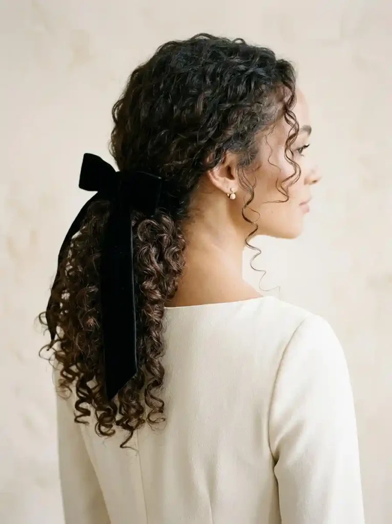 Low Curly Ponytail With a Bow